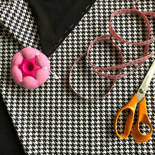 yellow handle scissors, measuring tape, and textles