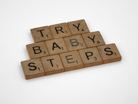 scrabble tiles spelling the words try, baby, steps
