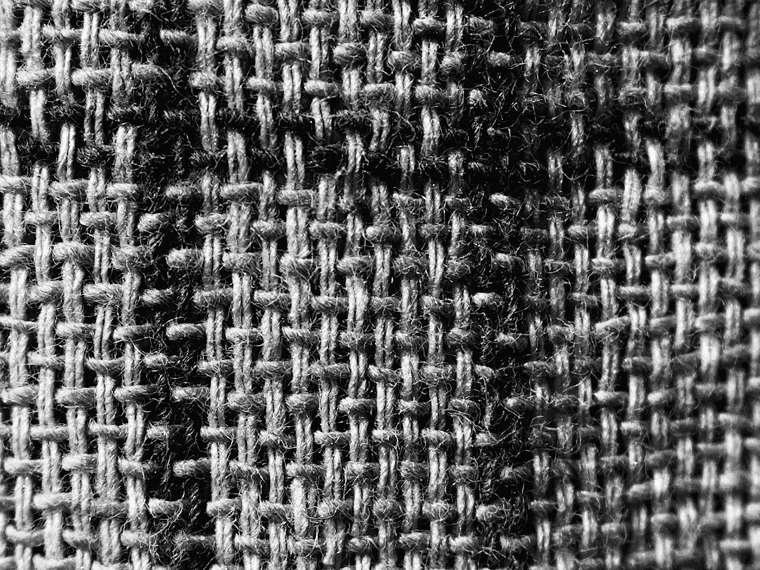 a black and white photo of a checkered fabric