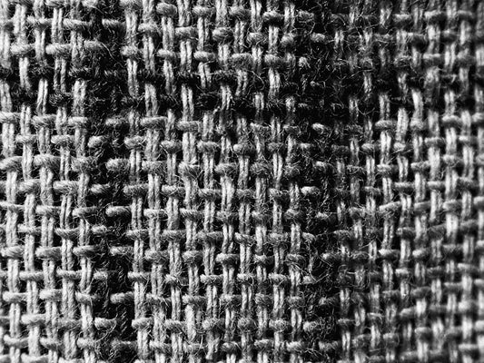 a black and white photo of a checkered fabric