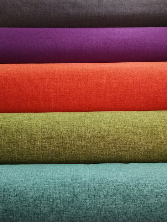 a stack of different colors of fabric