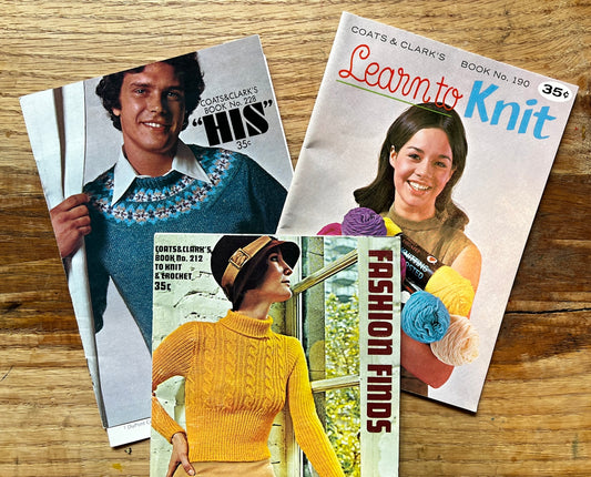 a couple of magazines sitting on top of a wooden table