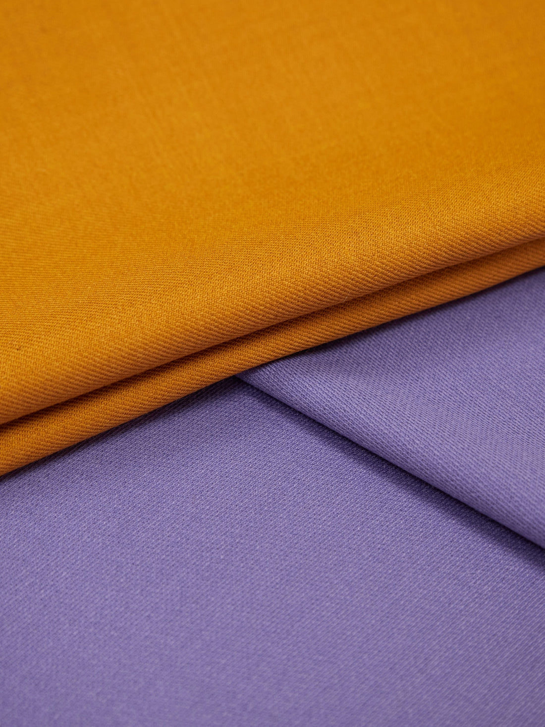a close up of a purple and yellow fabric