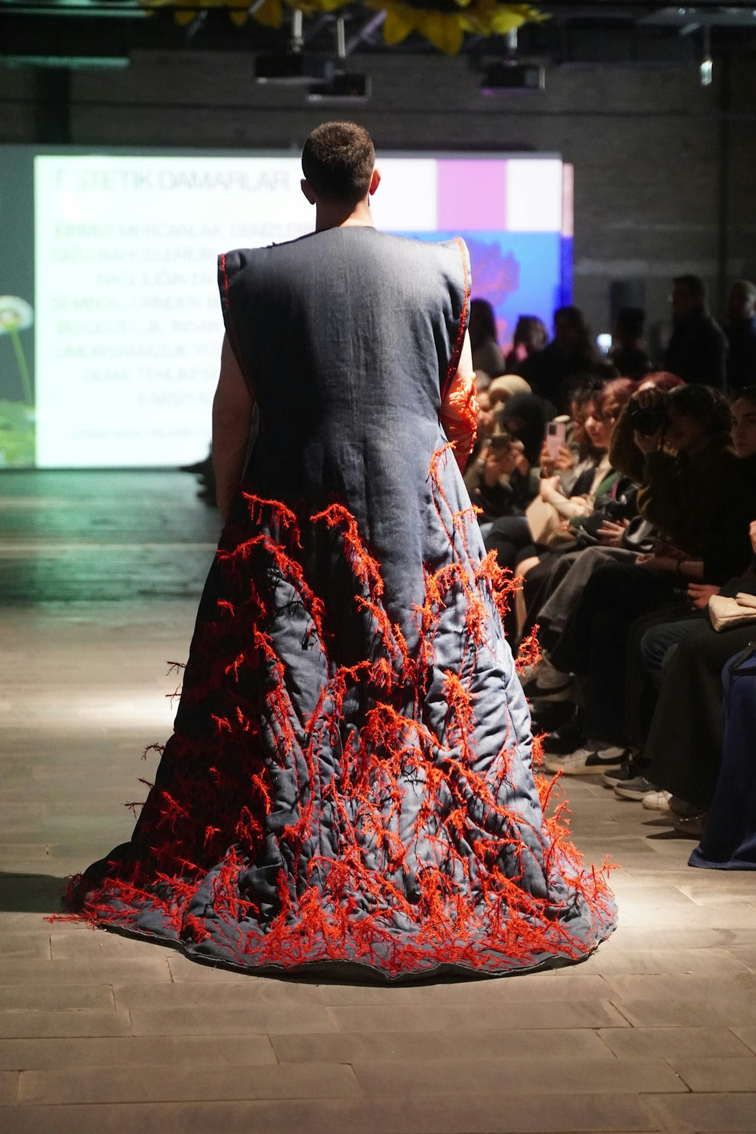Fashion model showcases a creative, avant-garde gown.