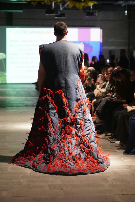 Fashion model showcases a creative, avant-garde gown.