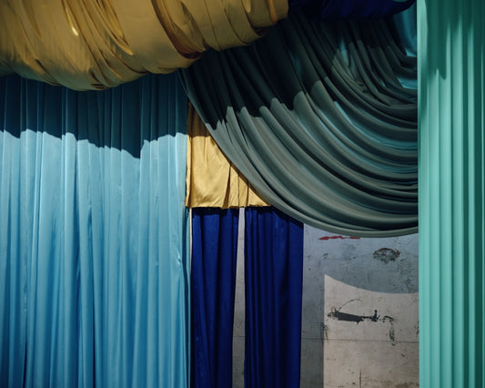 Colorful fabrics drape in a theatrical arrangement.