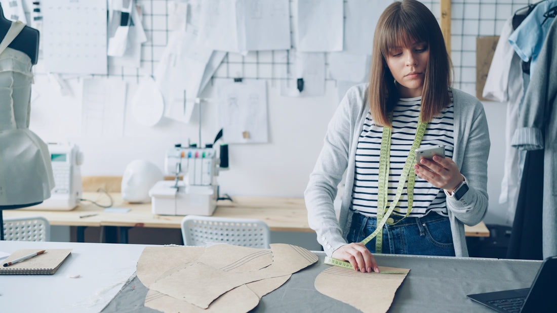 Fashion designer works on patterns in her studio.