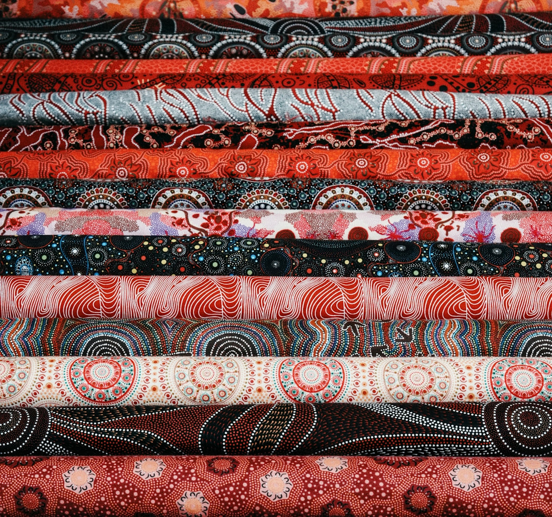 Colorful fabrics are neatly stacked and organized.