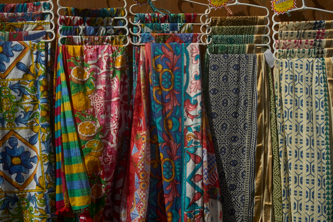 Colorful patterned fabrics hanging on display
