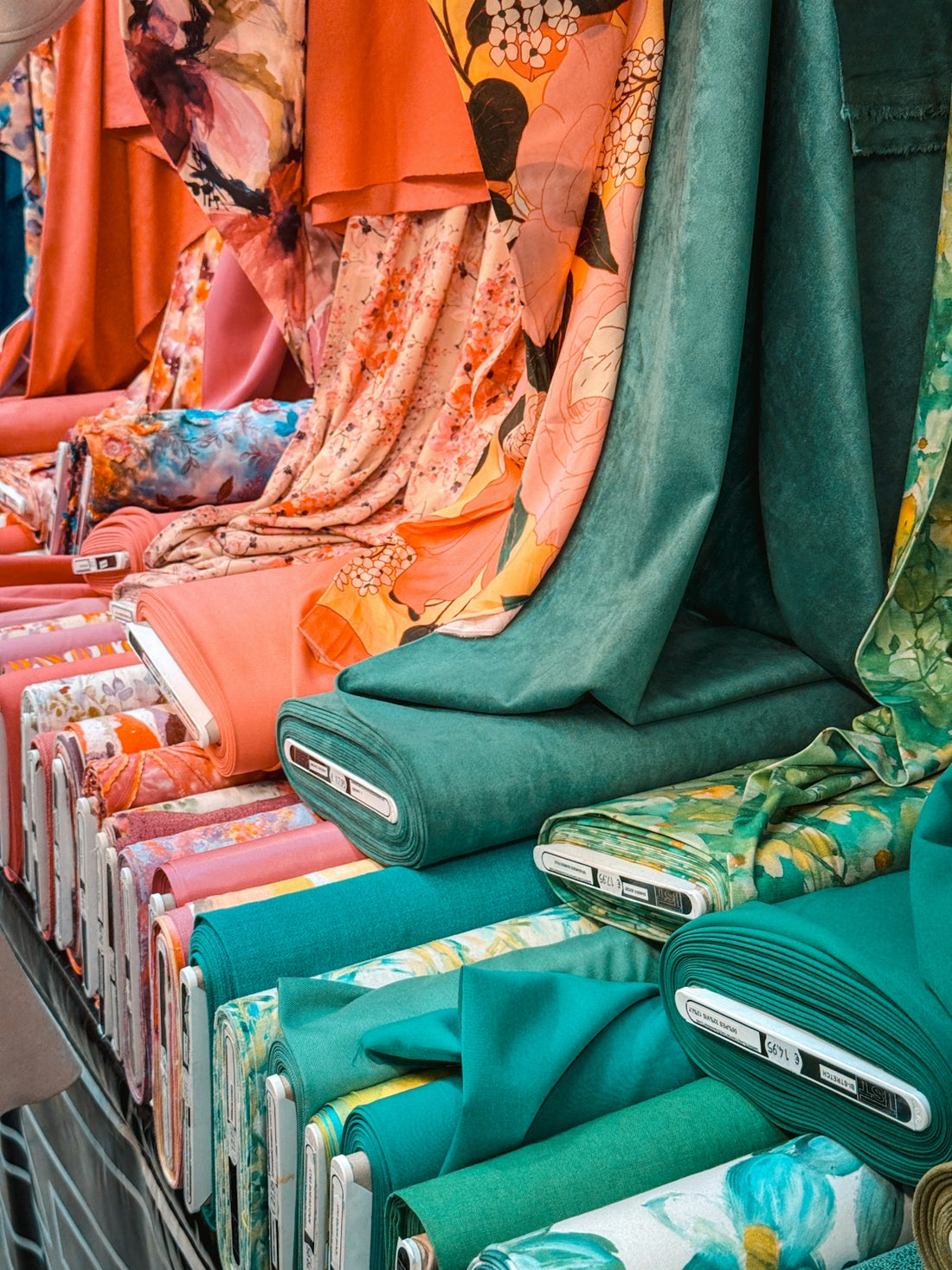 Colorful fabric rolls displayed at a market.