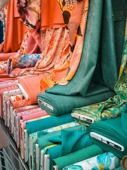 Colorful fabric rolls displayed at a market.