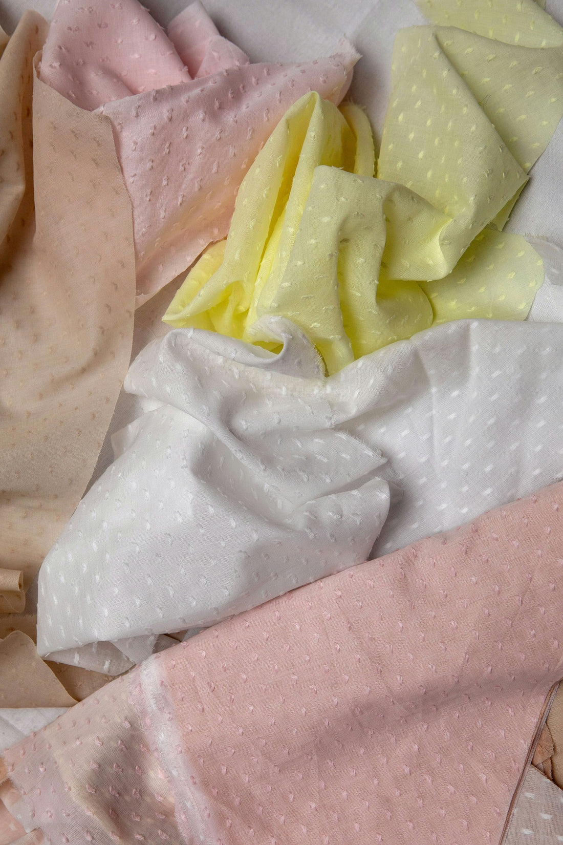 Soft pastel fabrics with subtle dot patterns